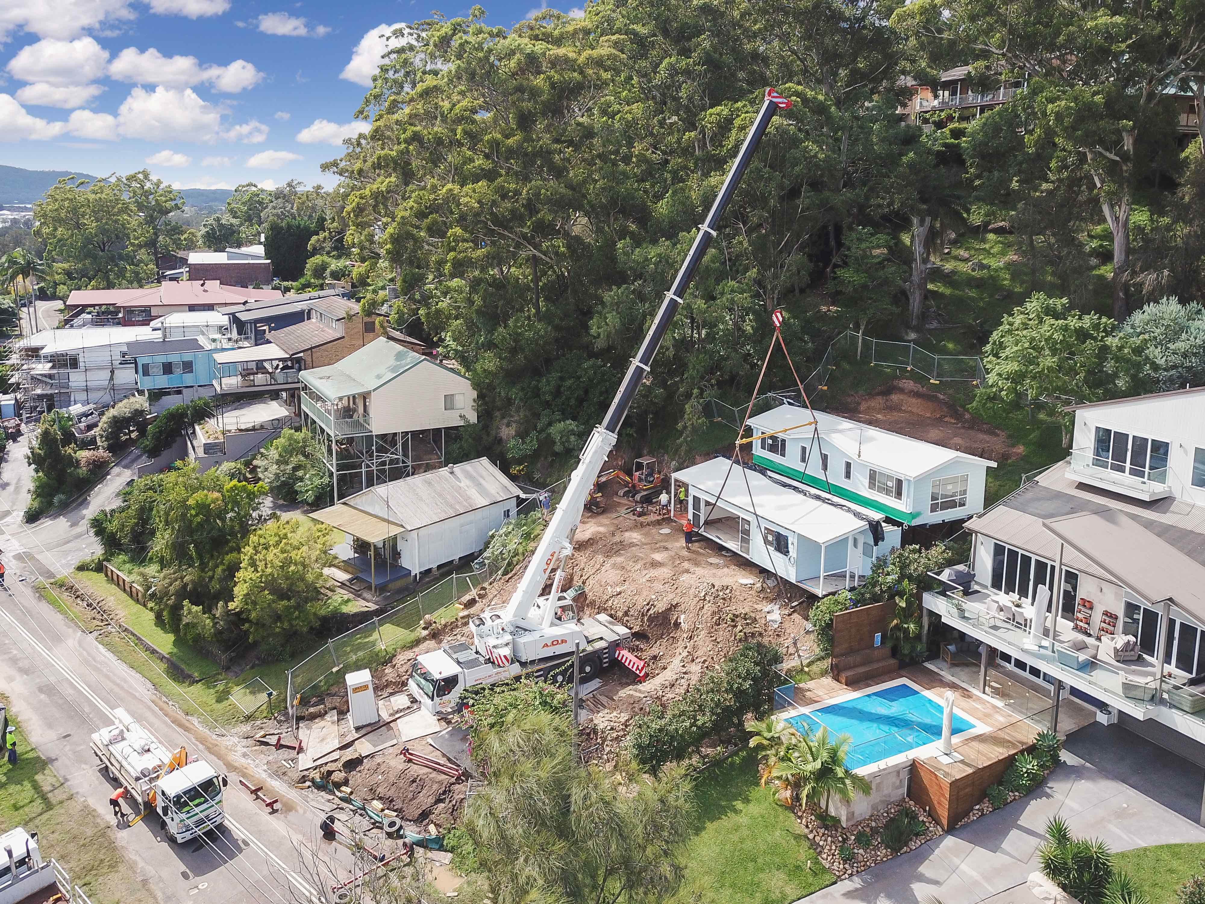 home getting craned onto steep slope